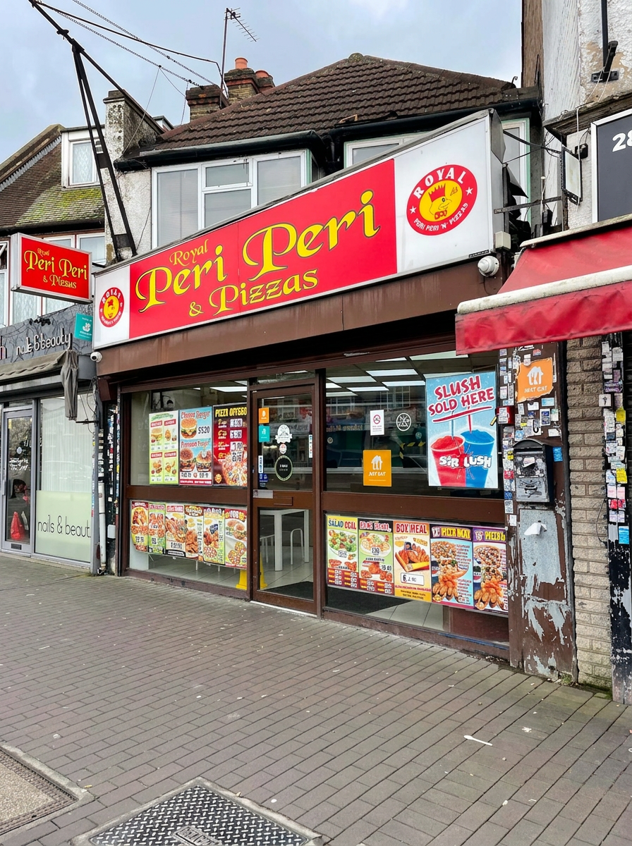 Royal Peri Peri & Pizzas shop front in Hayes Town with red and gold signage